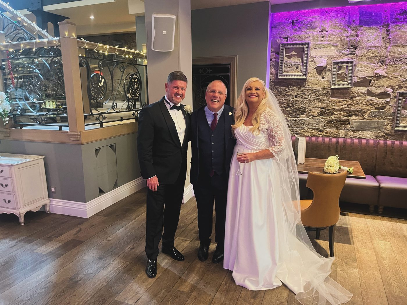 A couple in conversation with their humanist celebrant during a wedding planning meeting