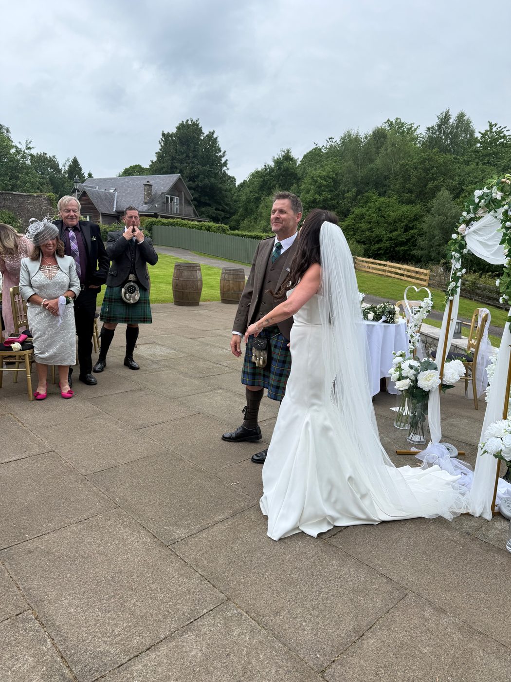 A couple exchanging vows outdoors at a Scottish wedding