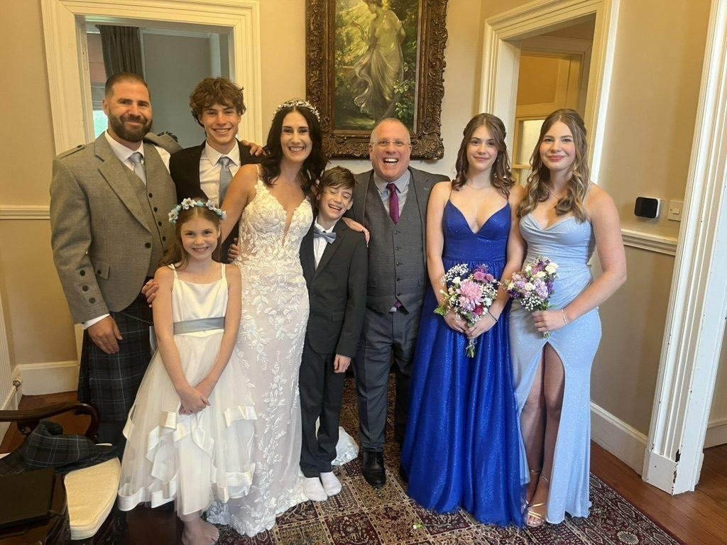 Sarah and Chris with their five children and celebrant John Paul inside the castle at Cardross after the ceremony